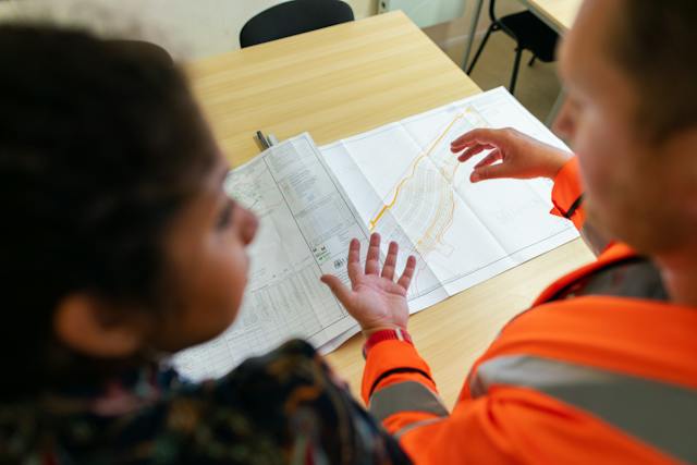 A contractor discussing plans with another person.