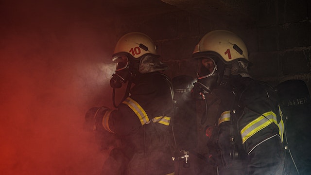 two firefighters surrounded by smoke
