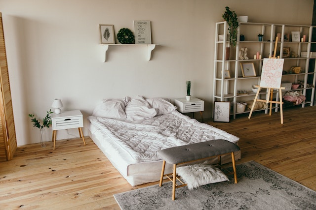 clean bedroom with wooden floor and beige walls